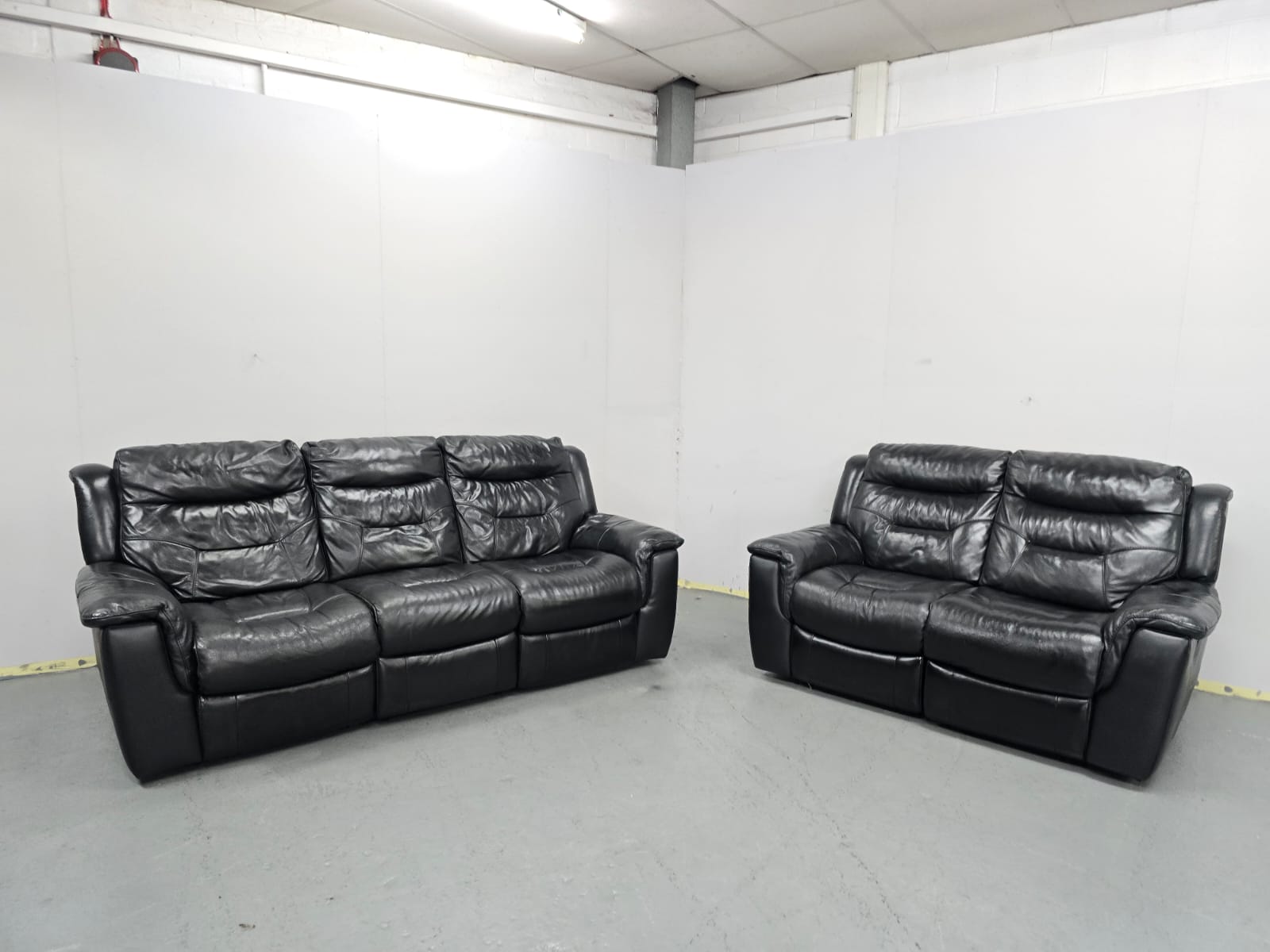Dfs Black leather 3 and 2 Seater Manual Recliner Sofas